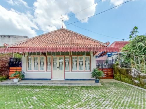a small house with a cross on top of it at RedDoorz near Alun-Alun Purwokerto 3 in Purwokerto