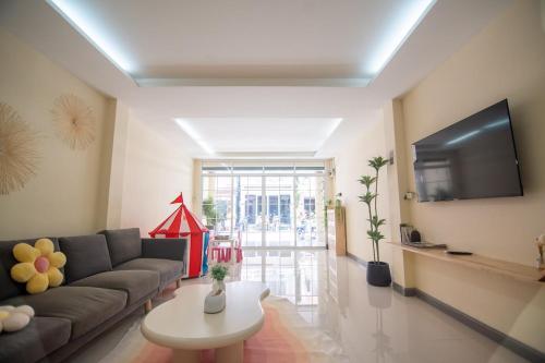 a living room with a couch and a tv at Beachfront 4-BR House in Patong in Patong Beach