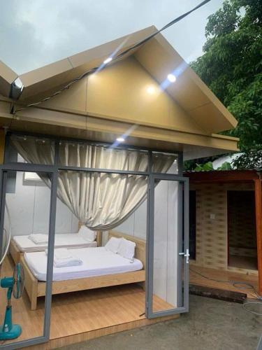 a bed under a roof on a patio at Huy Hoàng Homestay Kiên Giang in Lai Sơn