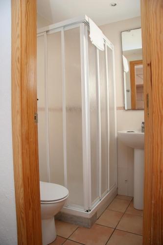 a bathroom with a shower and a toilet and a sink at Hostal Talamanca in Talamanca