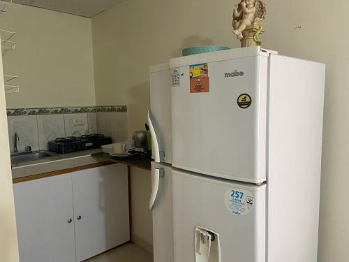 a white refrigerator in a kitchen with a counter at casa MH - rodadero in Gaira