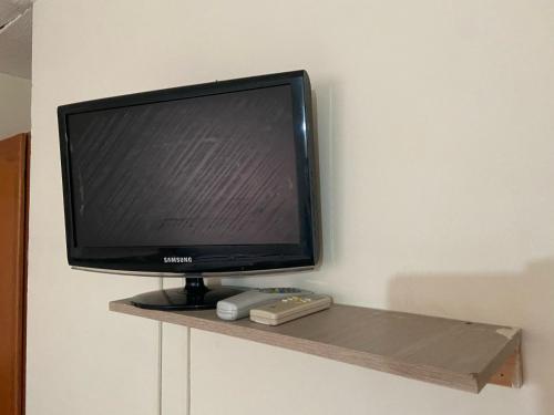 a television sitting on a shelf in a room at casa MH - rodadero in Gaira