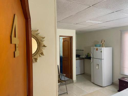 a kitchen with a white refrigerator in a room at casa MH - rodadero in Gaira