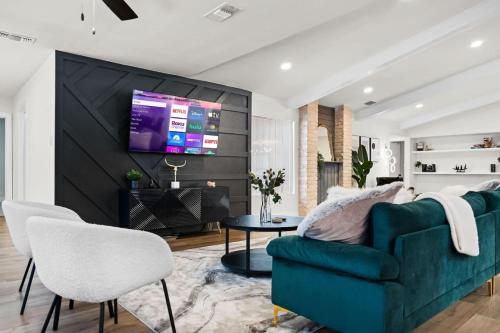 a living room with a couch and a tv on a wall at Spacious 6 Bed House Pet Friendly AFB in San Antonio