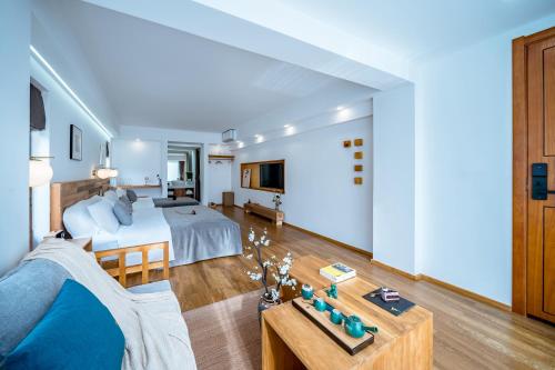 a hotel room with a bed and a living room at Dali Kong Xiang Weiwenshan Craft hotel in Dali