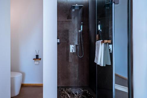 a bathroom with a shower with a glass door at Dali Kong Xiang Weiwenshan Craft hotel in Dali