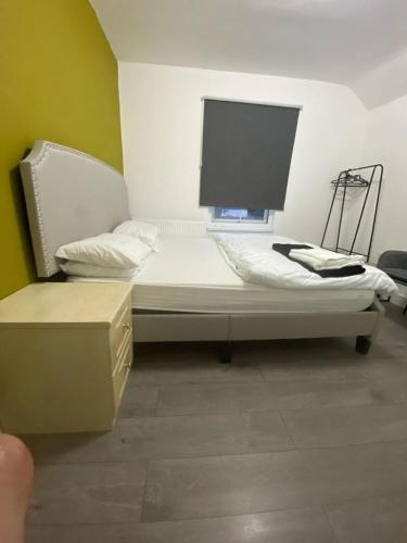 a room with a bed with a tv on it at Heathrow Close Comfort Room in Stanwell