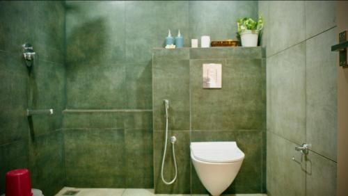 a bathroom with a shower and a toilet in it at Santa Maria - A Premium Boutique Homestay by the Sea I Trivandrum Airport 1mile in Trivandrum