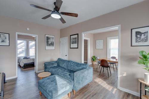 a living room with a blue couch and a ceiling fan at Prime 2BR Gem, Near Convention Hub! in Indianapolis