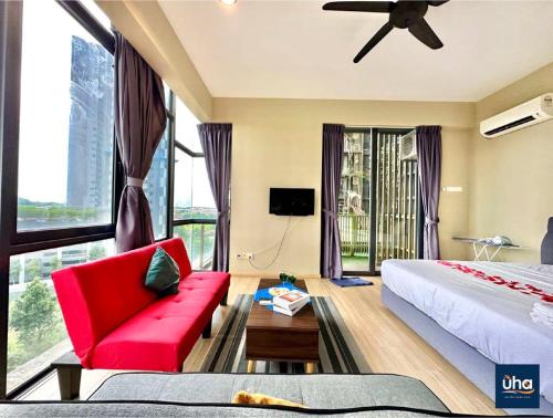 a hotel room with a red couch and a large window at Austin Cube 8 Teens by RR JBcity in Johor Bahru