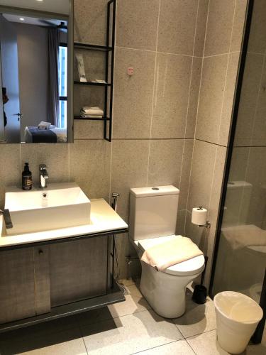 a bathroom with a toilet and a sink and a mirror at Millerz Square by MyKey in Kuala Lumpur