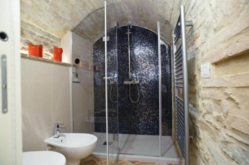 a bathroom with a shower with a toilet and a sink at Umbria nel cuore in Cannara