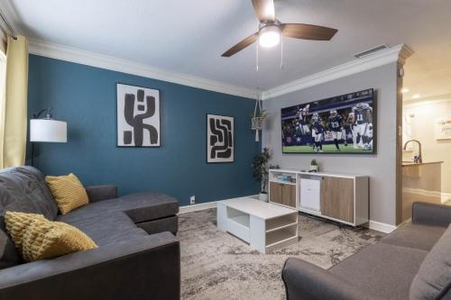 a living room with a couch and a tv at Rare Exclusive Retreat Private Hot Tub King Bed in Saskatoon