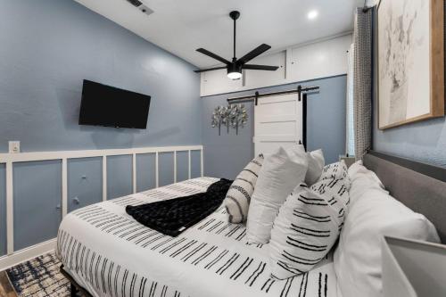 a bedroom with a bed with pillows and a flat screen tv at Rare Exclusive Retreat Private Hot Tub King Bed in Saskatoon