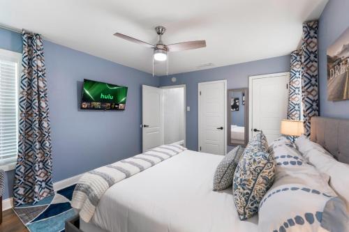 a bedroom with a large bed and a tv on the wall at Rare Exclusive Retreat Private Hot Tub King Bed in Saskatoon