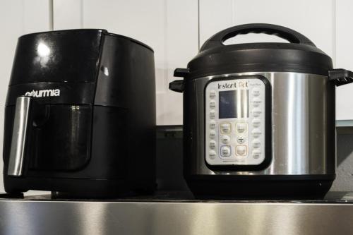a slow cooker and a toaster on a kitchen counter at Rare Exclusive Retreat Private Hot Tub King Bed in Saskatoon