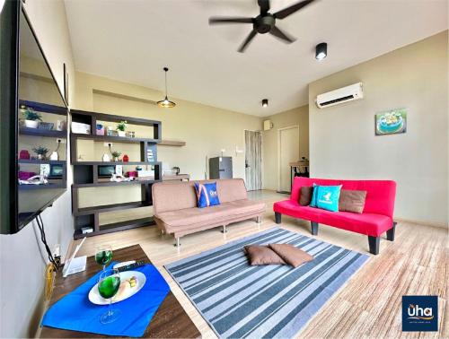 a living room with two chairs and a tv at Austin Cube 8 Teens by RR JBcity in Johor Bahru