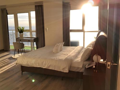 a bedroom with a large bed with a large window at 175 Sqm Luxurious Modern 3 Bedrooms Facing Manila Bay Sunset, Airports, Okada, Solaire, MOA in Manila