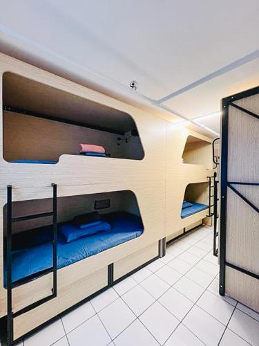 a room with three bunk beds in a room at The Espy Hostel in Cairns