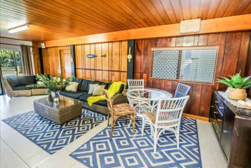 a living room with a couch and a table and chairs at A Lure - 100m to Main Beach in Agnes Water