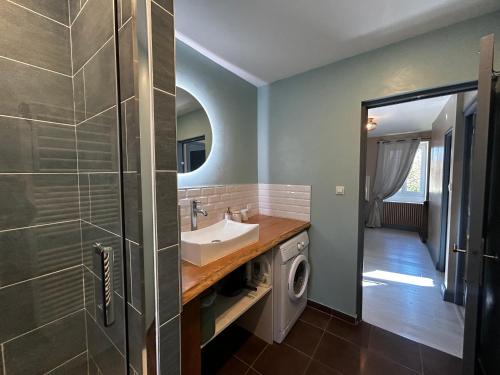 a bathroom with a sink and a washing machine at Gîte d'exception à Lésigny avec piscine couverte - FR-1-541-167 in Lésigny
