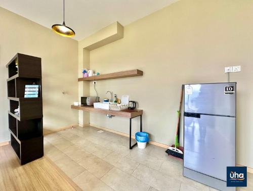 a kitchen with a counter and a refrigerator in a room at Austin Cube 8 Teens by RR JBcity in Johor Bahru