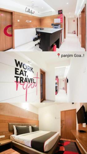 a room with a bed and a desk with writing on the wall at Aqua City Hotel in Panjim in Panaji