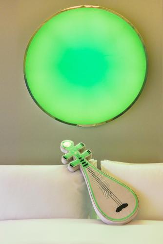a green mirror and a pair of scissors on a bed at W Suzhou - Jinji Lake in Suzhou