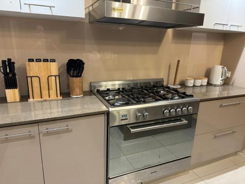a kitchen with a stainless steel stove top oven at Cozy family home near suft coast 6 beds in Grovedale