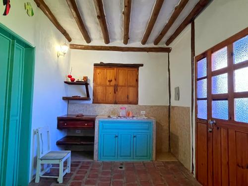 a kitchen with a blue island in a room at Posada Luisa Del Valle Guacuco in Playa Guacuco