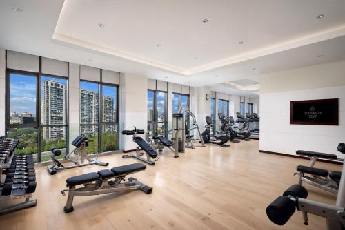 a gym with a lot of exercise equipment and windows at Sheraton Wenzhou Hotel in Wenzhou