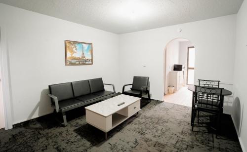 a living room with a couch and a table at 301 Bealey Ave Motel Very Close to City Centre and Hagley park in Christchurch