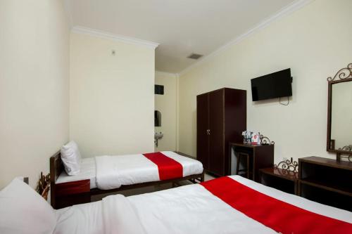 Ένα ή περισσότερα κρεβάτια σε δωμάτιο στο Esther Hotel