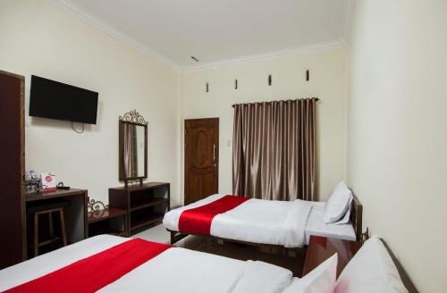 Ένα ή περισσότερα κρεβάτια σε δωμάτιο στο Esther Hotel