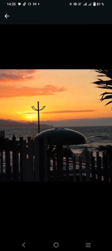 a cross on the beach at sunset with a surfboard at GRAND DIAMOND BEACH Tonsupa Atacames in Tonsupa