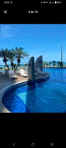 a picture of a swimming pool with a boat in the water at GRAND DIAMOND BEACH Tonsupa Atacames in Tonsupa