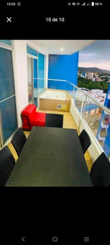 a room with a table and chairs on a boat at GRAND DIAMOND BEACH Tonsupa Atacames in Tonsupa