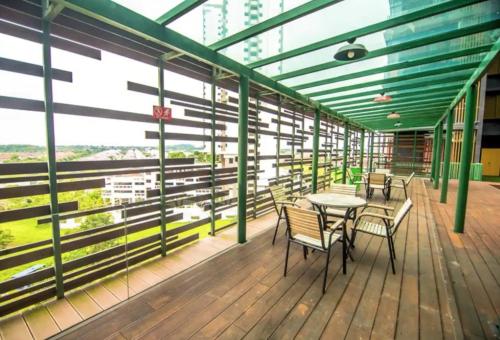 a room with a table and chairs on a balcony at Austin Cube 8 Teens by RR JBcity in Johor Bahru