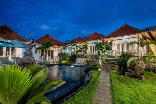 a villa with a swimming pool in front of a house at Blue Sky Villa Ceningan in Nusa Lembongan