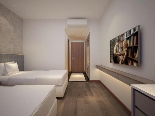 a bedroom with a bed and a book shelf at NGAN HA HOTEL in Ðại Tiêt