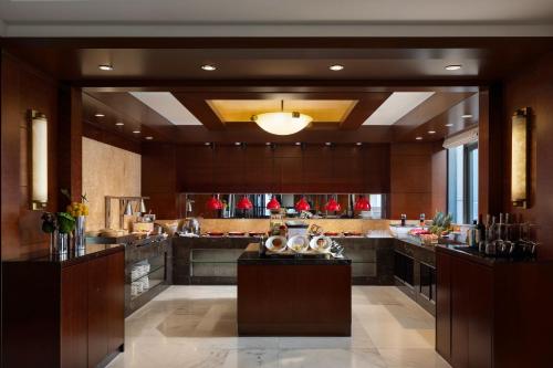 a large kitchen with a large island in a building at Sheraton Wenzhou Hotel in Wenzhou