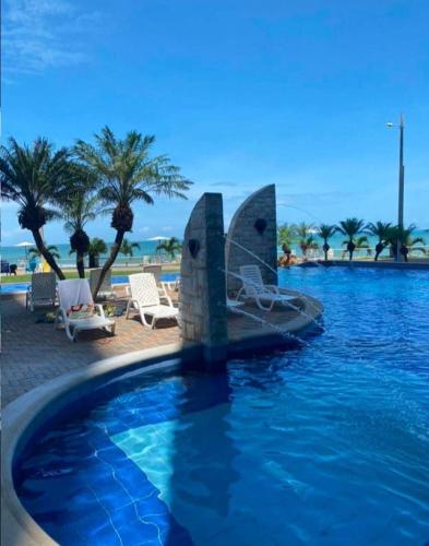 a swimming pool with a boat in the water at GRAND DIAMOND BEACH Tonsupa Atacames in Tonsupa