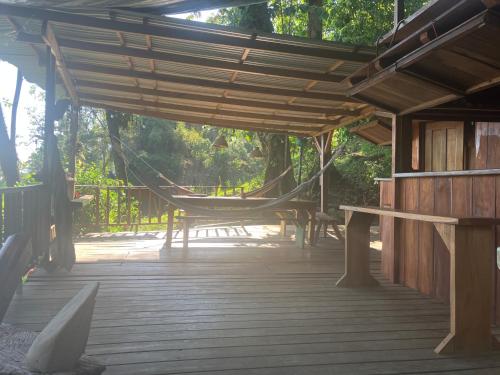 a porch with a hammock and a wooden deck at Villa ibiscus in Bastimentos