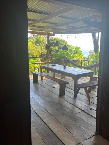 a picnic table on the deck of a house at Villa ibiscus in Bastimentos