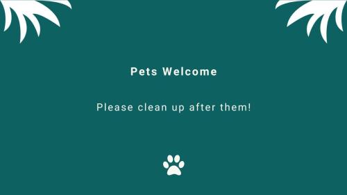 a picture of a paw print with the text pets welcome please clean up after them at Tambo Lindo in Smiths Lake