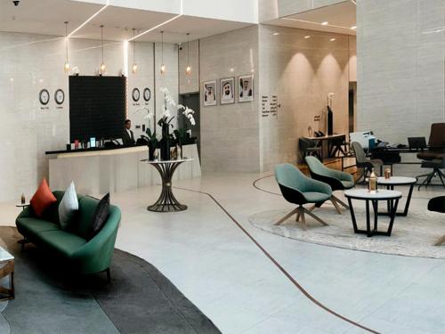 a lobby with couches and chairs in a store at Capital Suites Hotel Apartments in Abu Dhabi