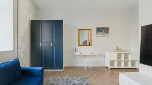 a living room with a blue cabinet and a table at Brand New Luxury Apartment, Parking, Center in Vilnius