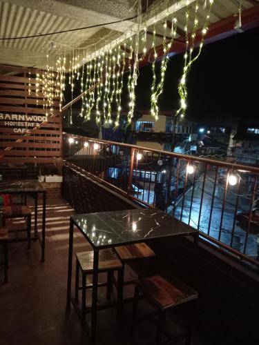 a restaurant with tables and lights hanging from the ceiling at Barnwood Homestay&cafe in Banaue
