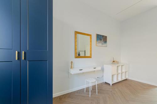 a room with a vanity and a mirror and a table at Brand New Luxury Apartment, Parking, Center in Vilnius