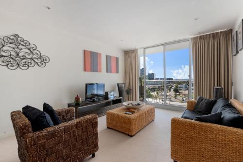 a living room with two couches and a tv at Comfortable 1-Bed Apartment with Balcony in Phillip